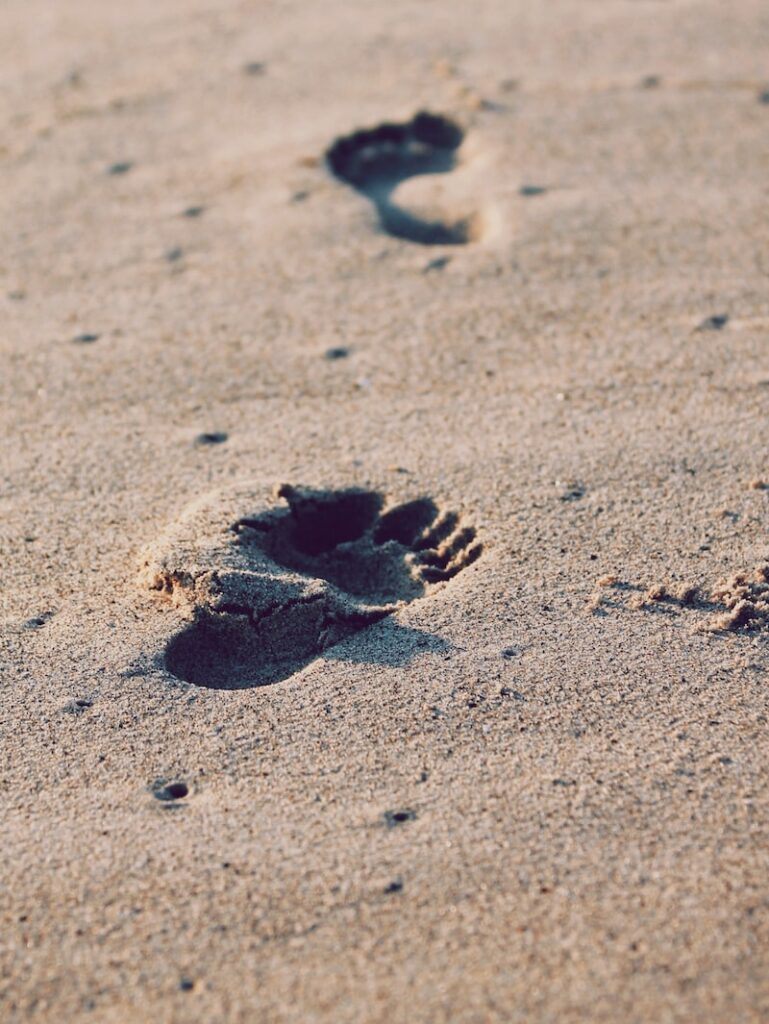 foot prints on beach sand