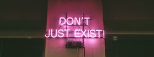 purple Don't Just Exist neon signage turned-on